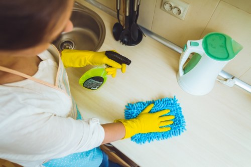 Technician inspecting a carpet cleaning machine and workspace for hazards